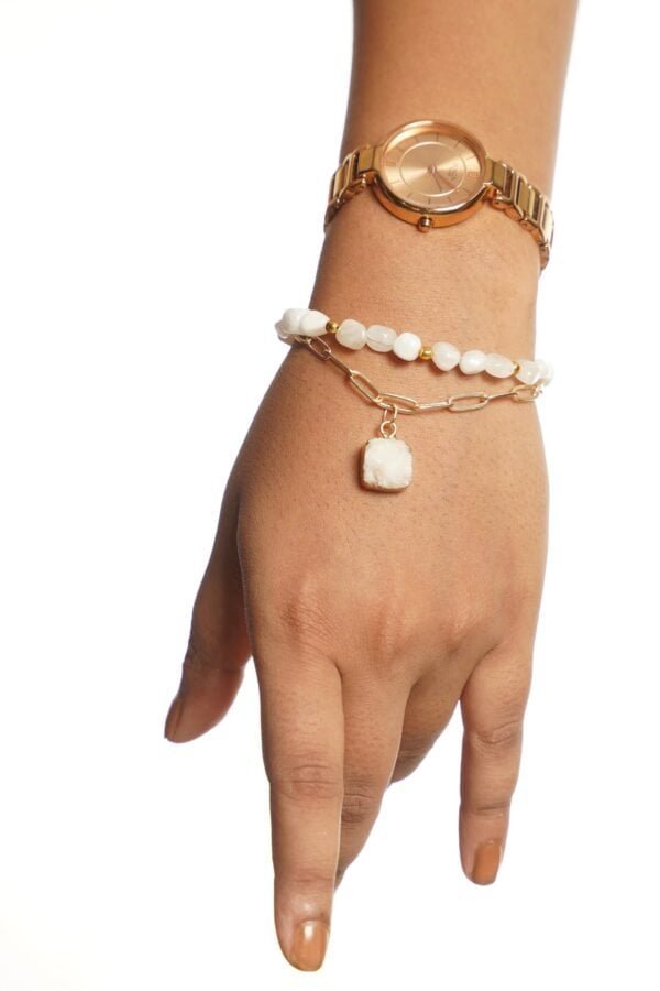 Elegant CharmBlanc bracelet with white beads and gold accents.