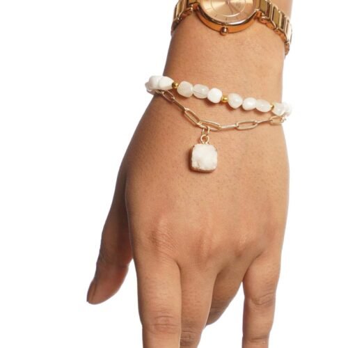 Elegant CharmBlanc bracelet with white beads and gold accents.