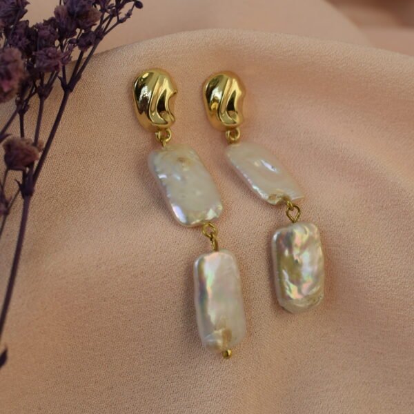 Elegant pearl and gold drop earrings for women.