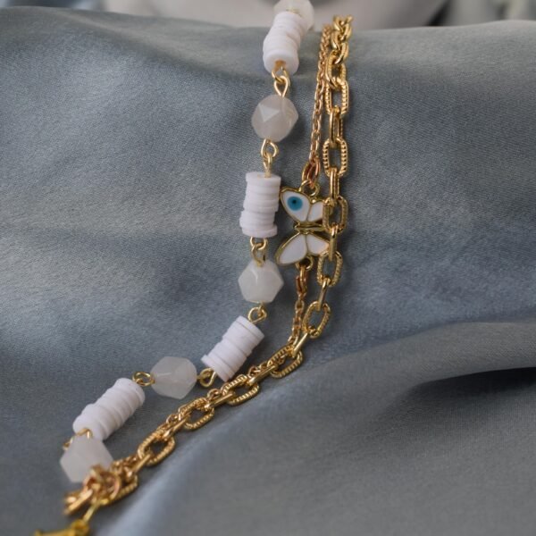 Evil Eye Butterfly Bracelet with gold chain and white beads for protection and style.