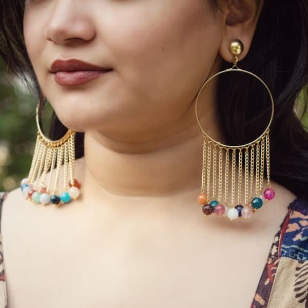 Colorful hoop earrings with dangling beads for a vibrant look.