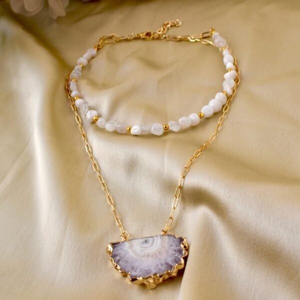 Elegant Frostfire Necklace with white beads and gold chain.