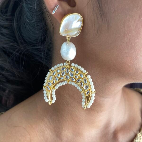 Shaped earrings with pearl accents, perfect for stylish accessories.