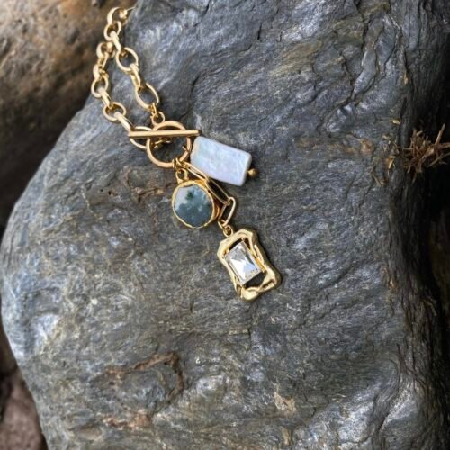 Elegant gold chain with gemstone charms for women.
