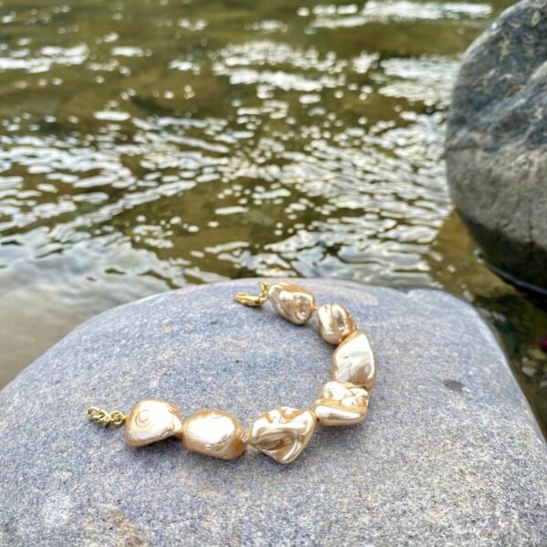 Elegant golden dusk bracelet with pearl accents for women.